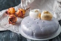 Sponge cake covered with a mirror glaze. Decorated with two white chocolate hearts. On a wooden background next to the cake are Royalty Free Stock Photo