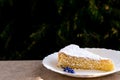 Sponge cake with cream and white chocolate decorate. Sliced piece of cake on white plate. Served on wooden table. Favorite dessert Royalty Free Stock Photo