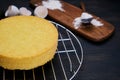 Sponge cake drying rack, flour and eggs. Ingredients for cooking biscuit on a black background