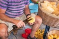 Sponge Cutter trims sea sponge tampon in street shop on Symi island Rhodes, Greece Royalty Free Stock Photo