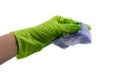 Sponge for dishes in a female hand in a green glove isolated on a white background. Copy space Royalty Free Stock Photo