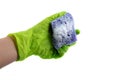 Sponge for dishes in a female hand in a green glove isolated on a white background. Copy space Royalty Free Stock Photo