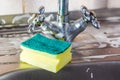 Sponge and foam solution on the kitchen sink. Royalty Free Stock Photo