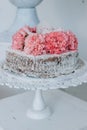 Sponge wedding cake decorated with flowers on a white pedestal Royalty Free Stock Photo