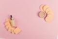 Sponges, a beautiful blender for applying foundation or powder and a bottle of concealer. Flat lay on a pink background, copy Royalty Free Stock Photo