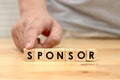 Sponsor writing on wooden cube blocks, word text typography arrange on wood table Royalty Free Stock Photo