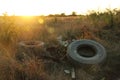 Spontaneous dump discarded tires and household rubbish . garbage dump on the side of a dirt road. The problem of recycling garbage