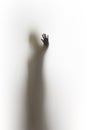 Diffuse silhouette of a human body, sharp hand and finger shadow.