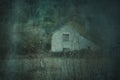 A spooky abandoned cottage in a feild in winter. With a grunge, artistic, edit