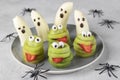 Spooky banana ghosts monsters and green kiwi monsters for Halloween party. Halloween Fruit Serving Idea