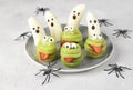 Spooky banana ghosts monsters and green kiwi monsters for Halloween party. Minimal Halloween Fruit Serving Idea