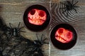 Spooky Halloween apple head punch table scene on a dark wood background