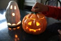 Spooky Halloween candlelights in a shape of a ghost and jack-o-lantern