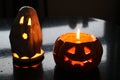 Spooky Halloween candlelights in a shape of a jack-o-lantern and ghost