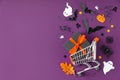 Spooky Halloween composition made of shopping basket and halloween decorations, sale. Royalty Free Stock Photo