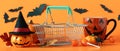 Spooky Halloween composition made of shopping basket and halloween decorations, sale. Royalty Free Stock Photo