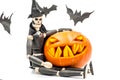 Spooky halloween pumpkin with bats and wooden puppet dead man