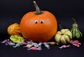 Spooky halloween pumpkin with eyes and candies stock images