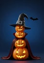 Spooky halloween pumpkin stack with witch hat and bat Royalty Free Stock Photo