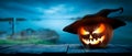 The spooky haunted evil glowing eyes of Jack O' Lanterns, halloween pumpkin, on the right of a wooden bench