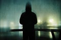 A spooky hooded figure. Standing by a river in a city on a foggy winters night. With a grunge, artistic, edit