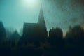 A spooky mysterious church and graveyard on a foggy night. With a grunge abstract edit