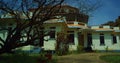 Spooky old haunted house with a dead tree. Royalty Free Stock Photo