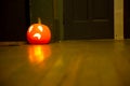 Illuminated orange halloween pumpkin floor door night