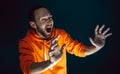 Close up portrait of crazy scared and shocked man isolated on dark background Royalty Free Stock Photo