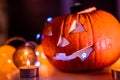 Spooky smiling halloween pumpkin in burning fire candles flames.