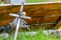 spooky wooden cross and glove in grassy ground