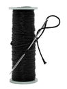 A spool of black thread and a needle on a white background. Synthetic thread isolate Royalty Free Stock Photo