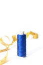Spool of blue thread for sewing and centimeter on a white background. Copy space Royalty Free Stock Photo
