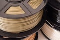 Spool of bronze PLA plastic filament for 3D printer.