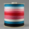 A spool of colorful yarn features multiple layers, each in different shades: blue, light Royalty Free Stock Photo
