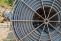 Spool of conduit at a worksite by the side of the road Royalty Free Stock Photo