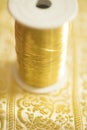 Spool of Gold-Colored Thread Royalty Free Stock Photo