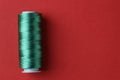 Spool of green sewing thread on red background, top view. Space for text Royalty Free Stock Photo