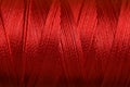 Spool of red sewing thread as background, closeup Royalty Free Stock Photo