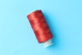 Spool of red sewing thread on light blue background, top view Royalty Free Stock Photo