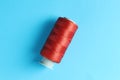 Spool of red sewing thread on light blue background, top view Royalty Free Stock Photo