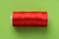 Spool of red sewing thread on light green background, top view Royalty Free Stock Photo
