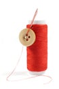 Spool of Red Thread with Needle and Button Isolated on White Royalty Free Stock Photo