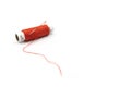 Spool of red thread with a needle isolated on white background. Red thread and needle isolated on white background Royalty Free Stock Photo