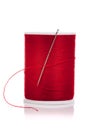 Spool of red thread and needle on white Royalty Free Stock Photo