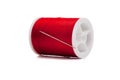 Spool of red thread and needle on white Royalty Free Stock Photo