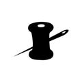 Spool of thread with a needle silhouette in black in a flat style on a white isolated background