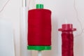 Spool of Thread and Needle, red spool of thread mounted on the sewing machine Royalty Free Stock Photo