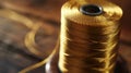 A spool of thread sitting on top of a wooden table, useful for sewing and crafting projects Royalty Free Stock Photo