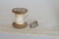 Spool of thread, thimble and sewing needle Royalty Free Stock Photo